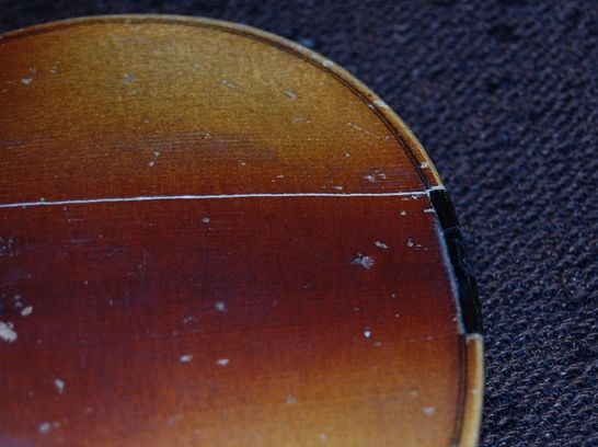 Saddle crack in a cheap fiddle.