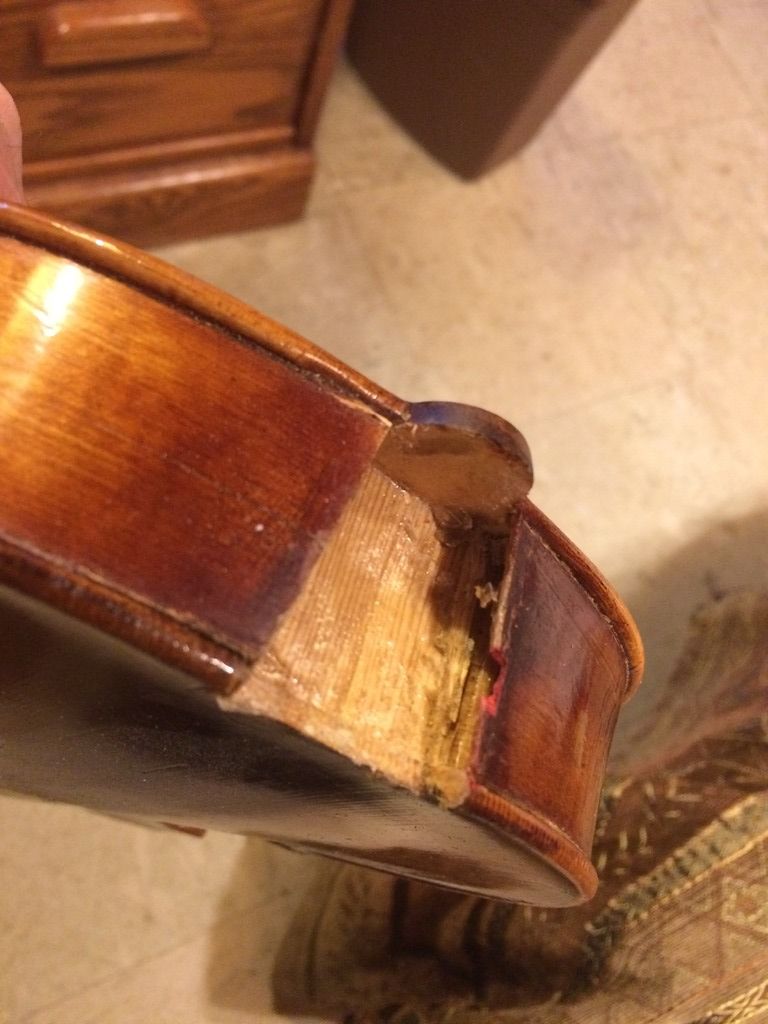Missing wood from both the neck block and the treble rib