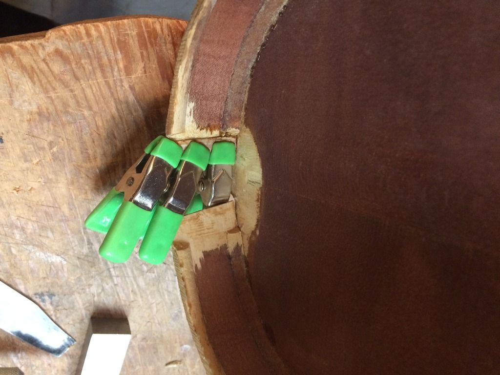 New rib wood glued and clamped in place, on the treble rib. The bass rib is also cracked.