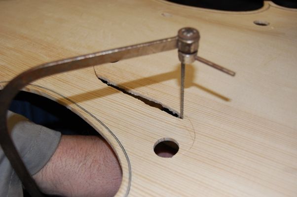 Cutting out the f-holes with a coping saw.