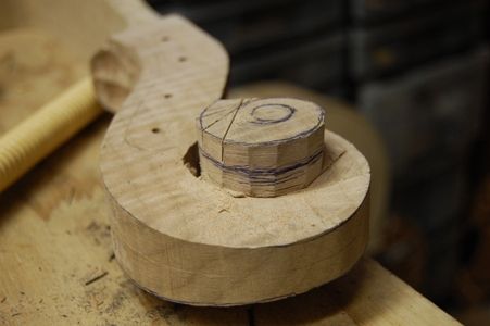 Cutting a series of kerfs for wood removal in carving a scroll.