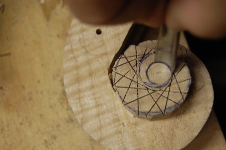 Using a gouge to outline the eye of the scroll.