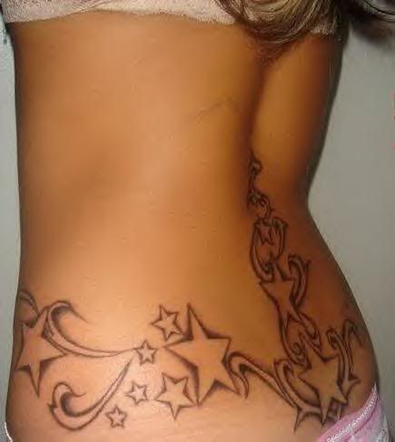 Sexy girl with a tattoo design of stars on the lower back and waist line